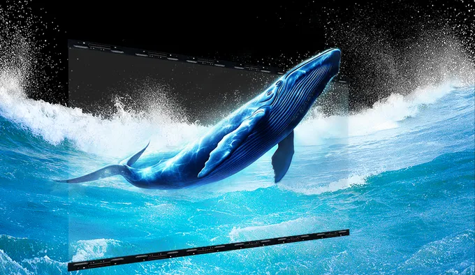 Transparent mesh LED screen showing a breaching whale over the ocean, demonstrating high transparency