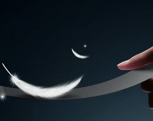 A feather resting on a flexible transparent mesh LED strip, illustrating its light 6 kg/m² weight