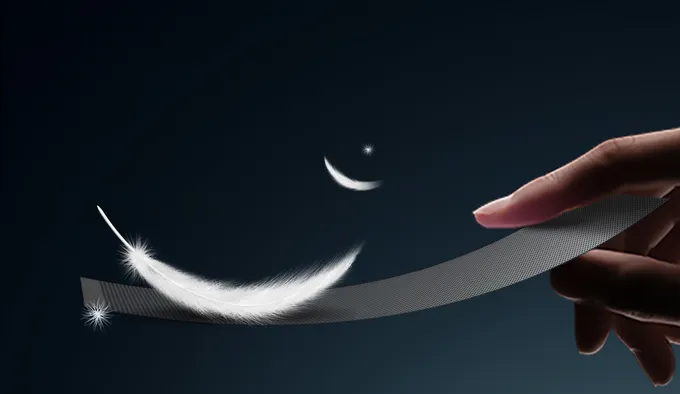 A feather resting on a flexible transparent mesh LED strip, illustrating its light 6 kg/m² weight
