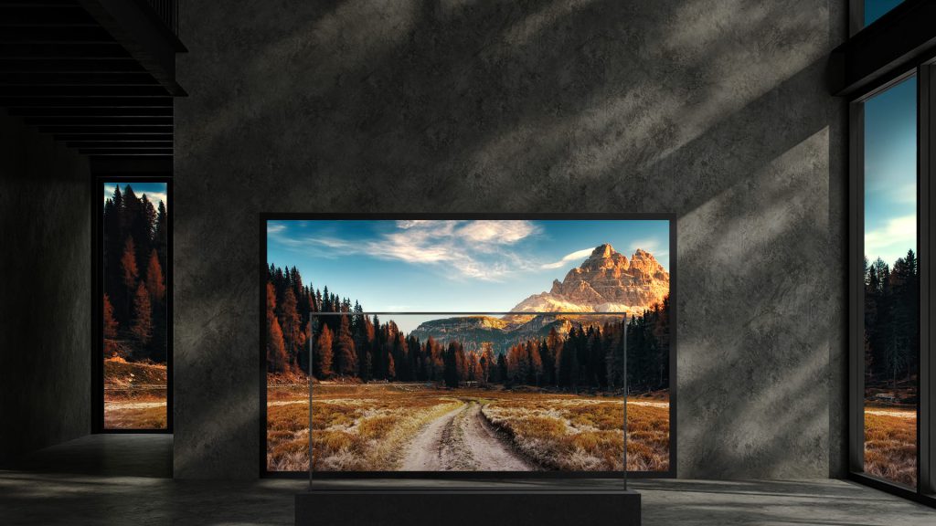 Transparent OLED display in a modern interior showing an autumn mountain landscape